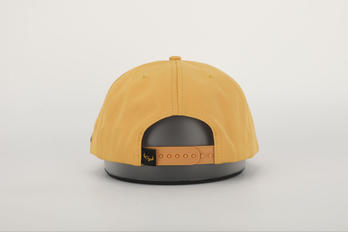 A mustard yellow snapback hat with 'BOURBON COWBOY' embroidered on the front. Back View