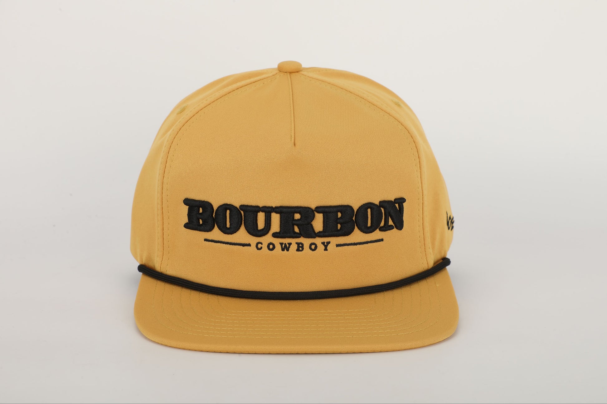 A mustard yellow snapback hat with 'BOURBON COWBOY' embroidered on the front. Front View