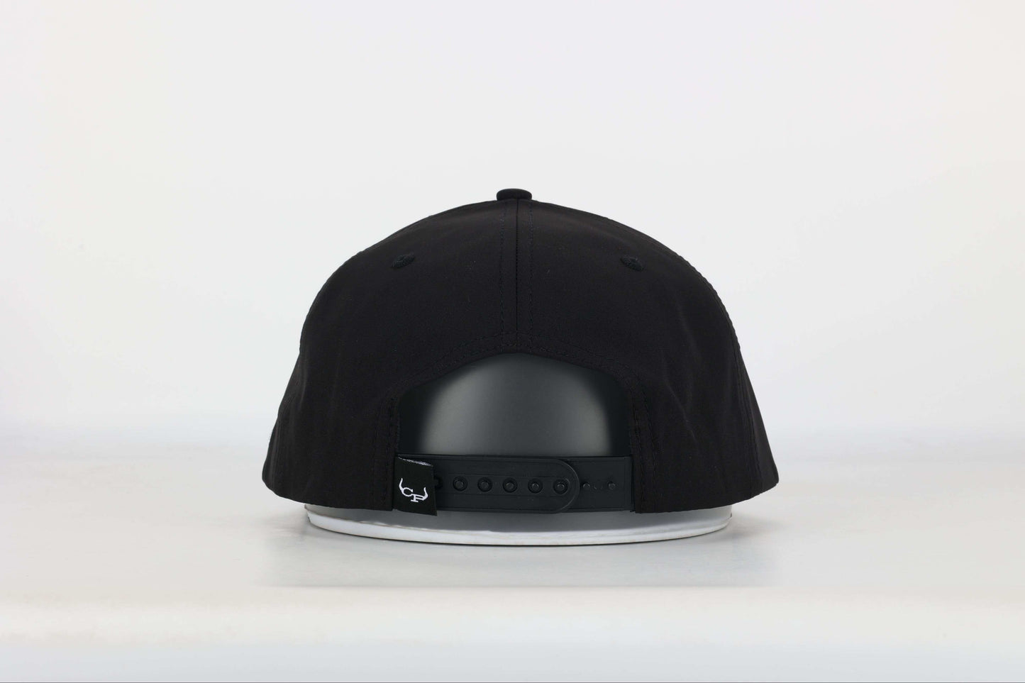 Black cap with a embroidered logo of a longhorn with texts that says 'BRAND RANCH' in white bold 3d embroidery. Back View