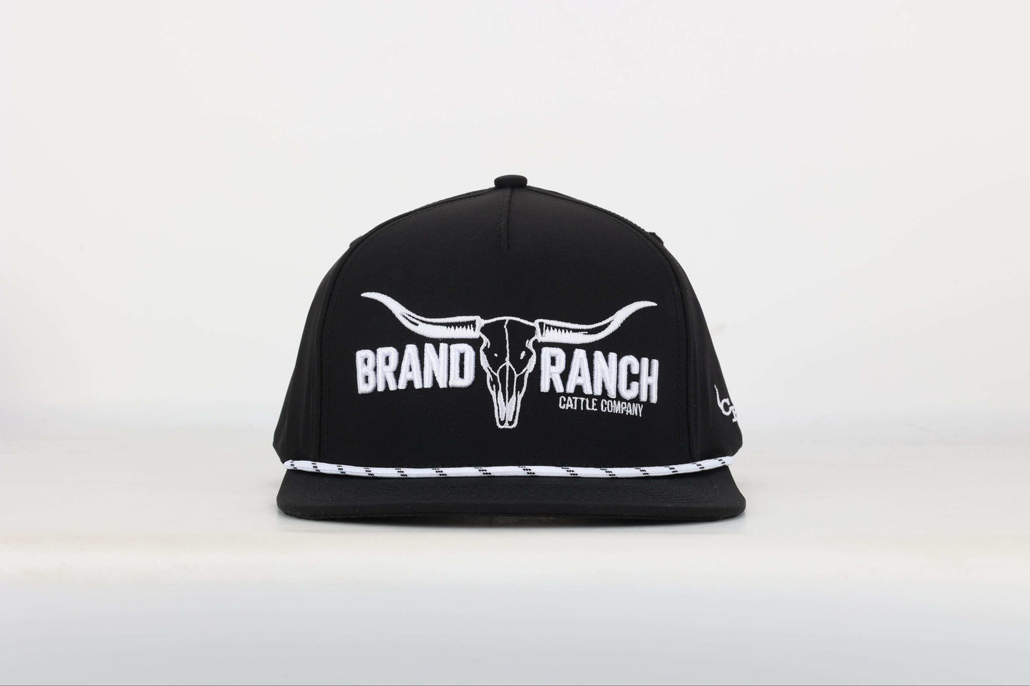 Black cap with a embroidered logo of a longhorn with texts that says 'BRAND RANCH' in white bold 3d embroidery. Front View