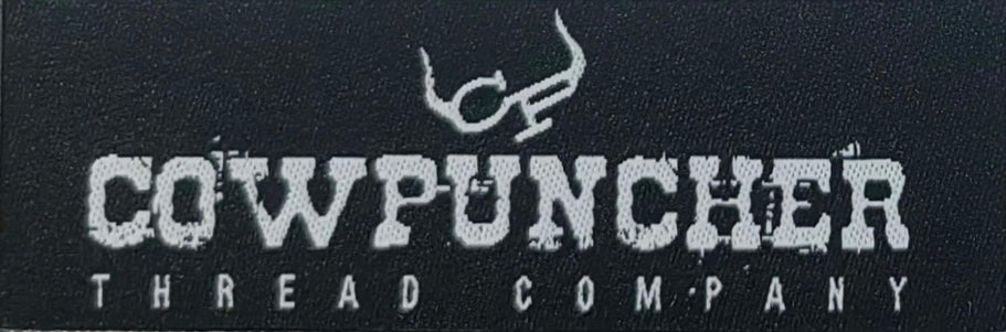A black woven hat patch with white text and logo that reads 'COWPUNCHER THREAD COMPANY'.