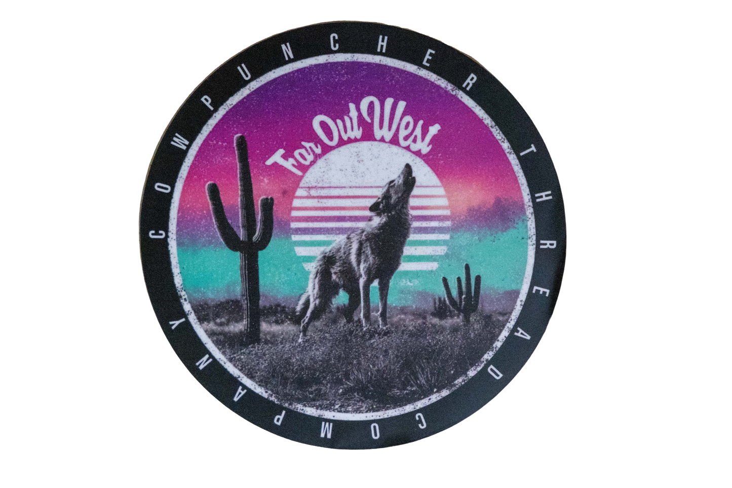 Round sticker with a coyote in the desert with cactus, with a purple and blue sunset design in the background