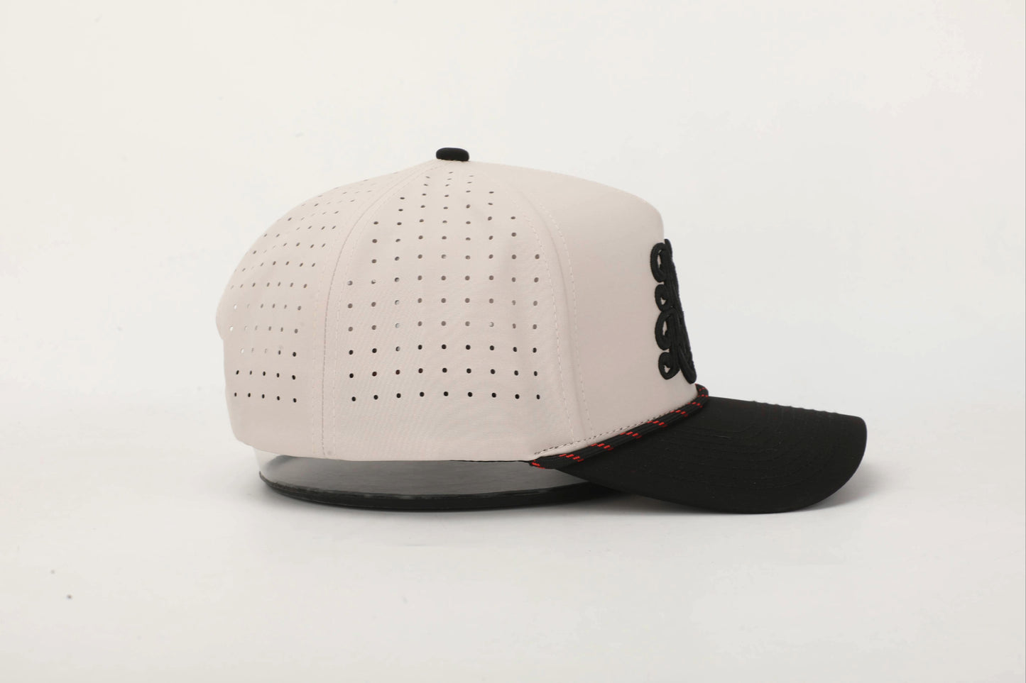 Beige and Black cap with 'Rank & Reckless' logo on the front with a Black and Red rope. Left Side View.