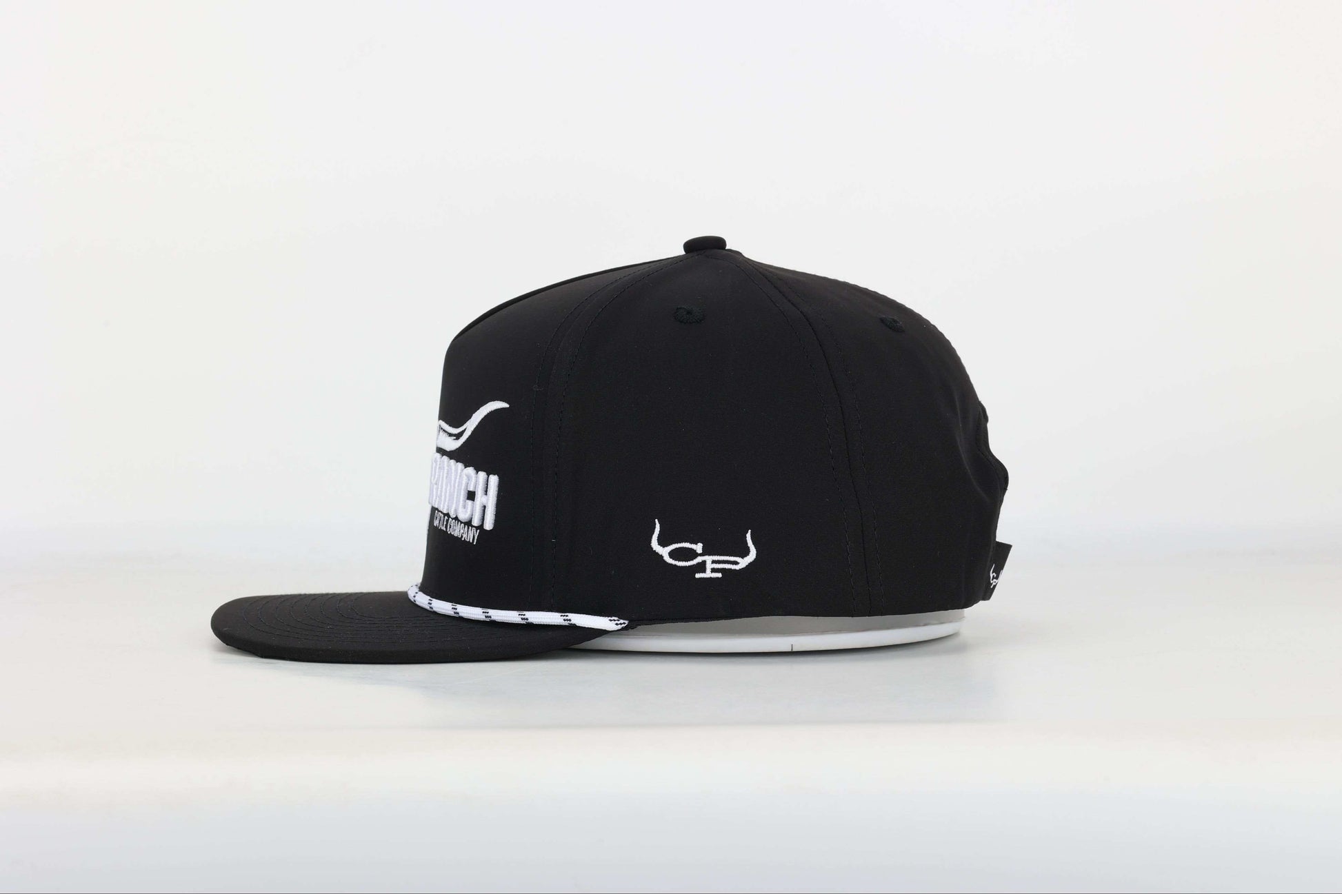 Black cap with a embroidered logo of a longhorn with texts that says 'BRAND RANCH' in white bold 3d embroidery. Right Side View