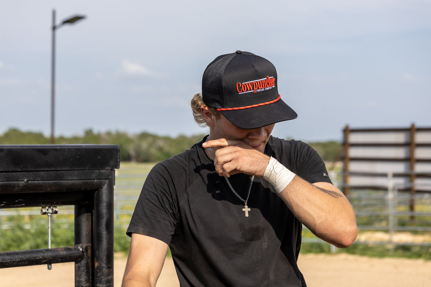 Bull Rider, Gavan Hauck, Wearing a black Snapback Cap with red & white embroidery.