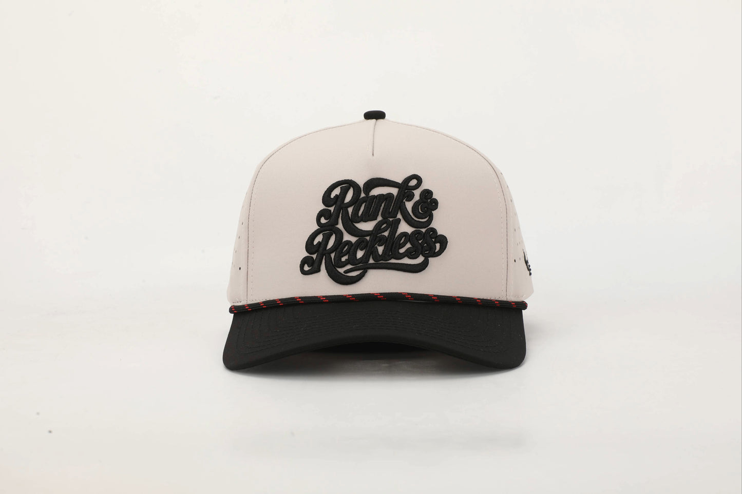 Beige and Black cap with 'Rank & Reckless' logo on the front with a Black and Red rope. Front View.