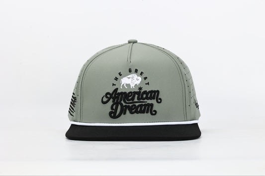 Olive green and black snapback cap with "The Great American Dream" embroidered on the front in black and white, featuring a white buffalo design. Front View